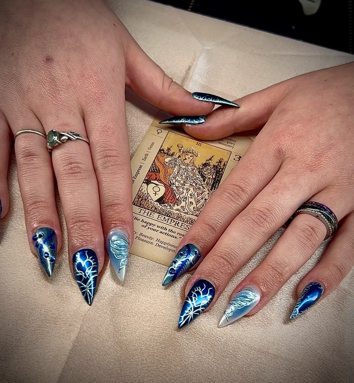 Dramatic blue lightning-storm stiletto nail art, by Victoria